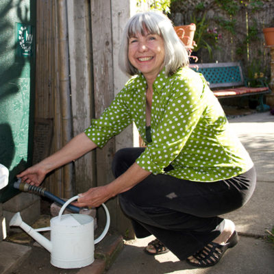photo of a Soquel Creek Water District customer saving water by utilizing a rain barrel